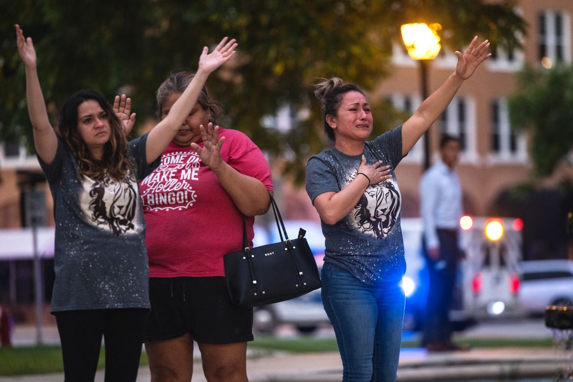 People become emotional at the City of Uvalde Town Square during a prayer vigil