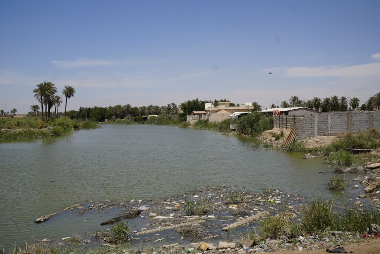 Shatt al Arab River with pollutants, showing on right side some residential houses were built while it was green lands.