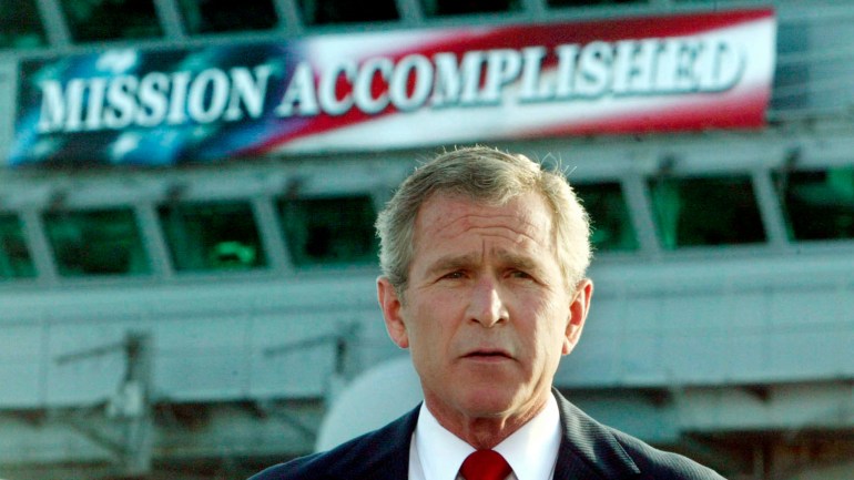 US President George W Bush announces the end of major combat operations in Iraq on May 1, 2003, aboard the aircraft carrier USS Abraham Lincoln. A large banner behind him reads 'Mission Accomplished'.
