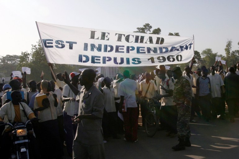 Secondary school students take part in an anti-French demonstration as riot police watch, in the capital N'Djamena November 14, 2007.