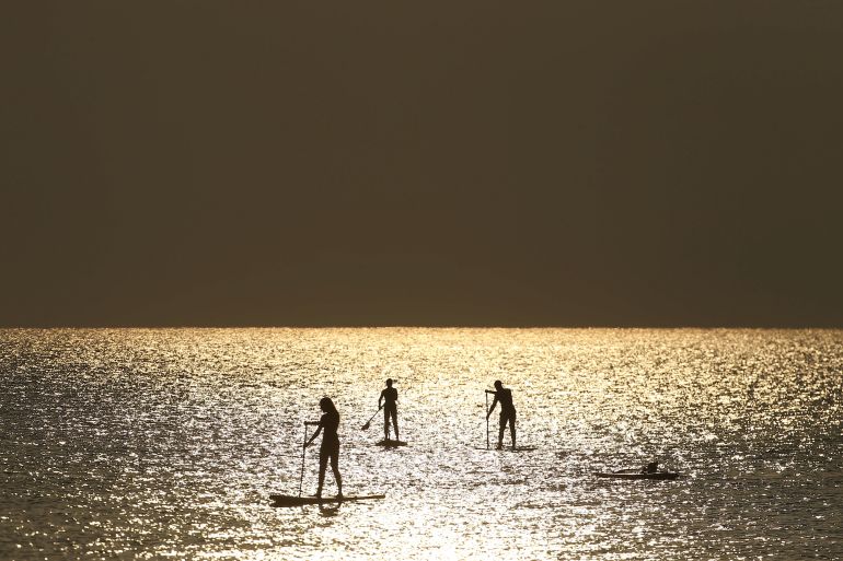 People paddle on stand-up boards in Cyprus