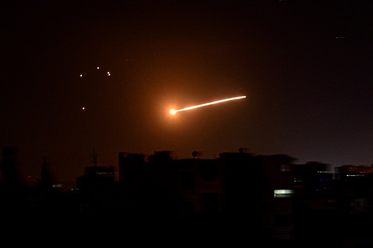 A streak of light is seen in the night sky. [File: SANA/Reuters].