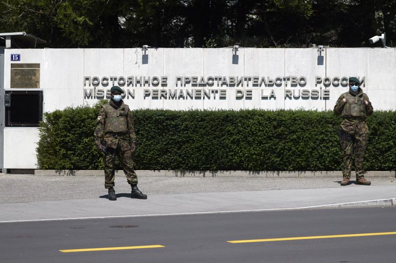 Swiss army soldiers stand guard outside the Russian Mission in Geneva, Switzerland