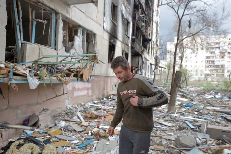 Local resident Viacheslav walks on debris of a residential building damaged by a military strike, as Russia's attack on Ukraine continues, in Sievierodonetsk, Luhansk region
