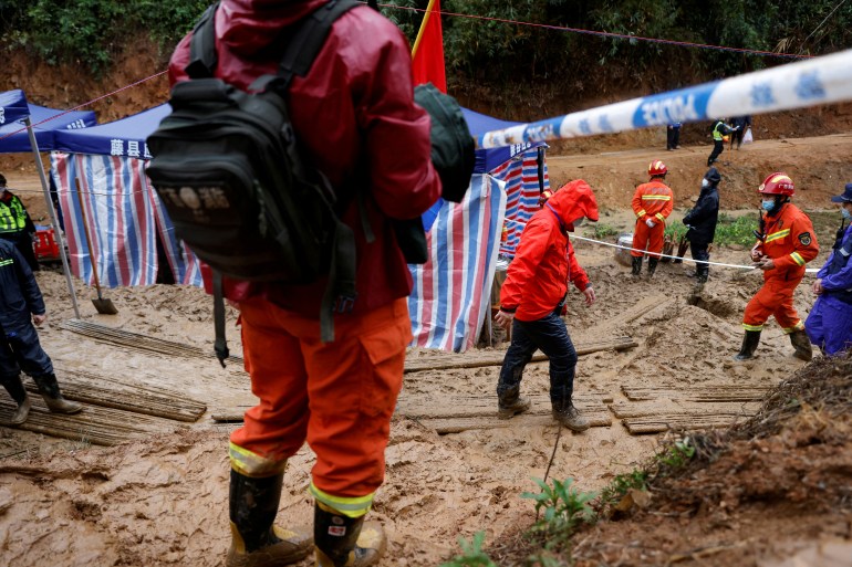 Rescue workers at the site where a China Eastern Airlines Boeing 737-800 plane crashed on March 24, 2022.
