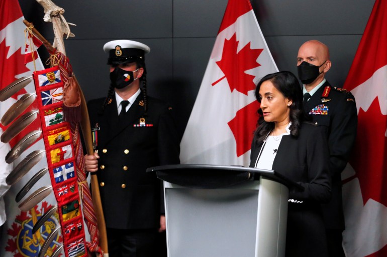Canada's Defence Minister Anita Anand speaks at a podium