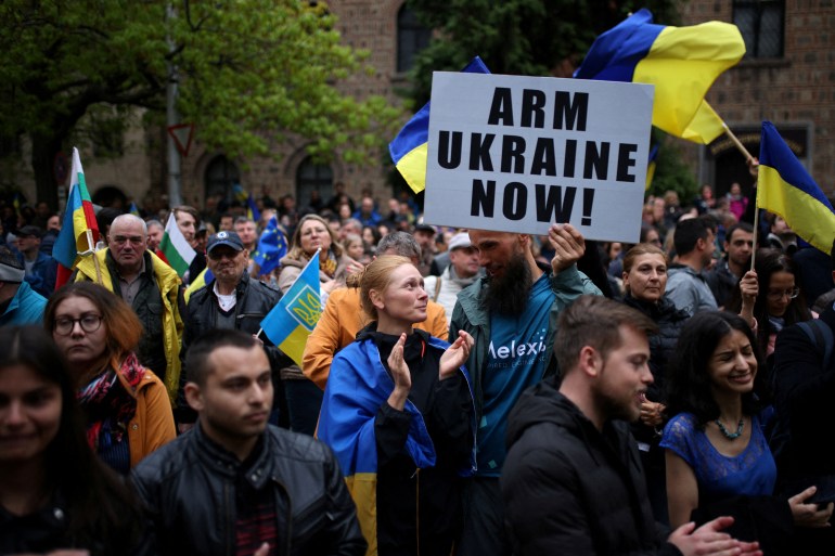 People take part in a demonstration urging the government to provide arms and ammunition aid to Ukraine