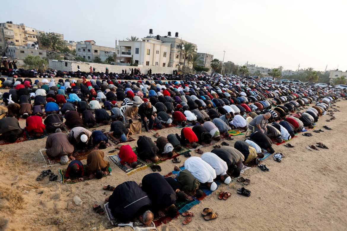 People perform morning prayers to celebrate Eid al-Fitr, marking the end of the holy fasting month of Ramadan, in Khan Younis, in the southern Gaza Strip