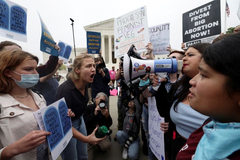 pro- and anti-abortion demonstrators shout at each other outside the US Supreme Court
