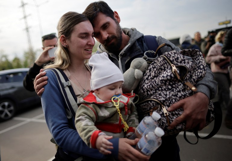 A family of Ukrainian evacuees from Mariupol is seen arriving in Zaporizhzhia
