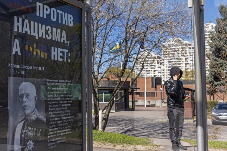 A poster with a portrait of King Gustaf V of Sweden and the message "We are against Nazism, they are not" is installed at a bus stop near the Swedish embassy in Moscow