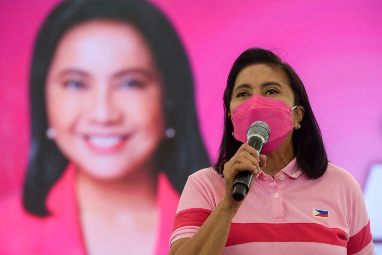 Philippine Vice President Leni Robredo in signature pink t-shirt and mask speaks at a rally