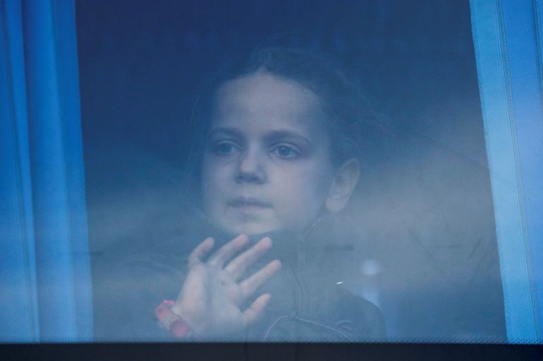 A girl looks through the bus window as civilians evacuated from Azovstal steel plant in Mariupol arrive at a temporary accommodation centre in the village of Bezimenne, during Ukraine-Russia conflict in the Donetsk Region, Ukraine May 6, 2022.