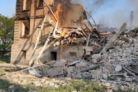 Debris is seen next to a partially collapsed building is seen, after a school building was hit as a result of shelling, in the village of Bilohorivka, Luhansk, Ukraine