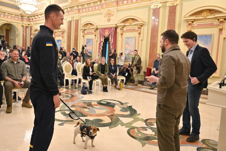 Canadian Prime Minister Justin Trudeau and Ukraine's President Volodymyr Zelenskiy award service dog "Patron" during a news conference 