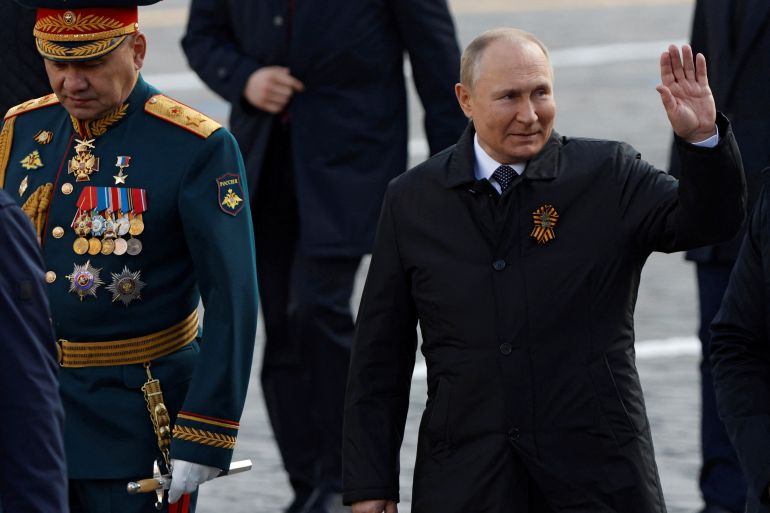 Russian President Vladimir Putin and Defence Minister Sergei Shoigu walk after a military parade on Victory Day