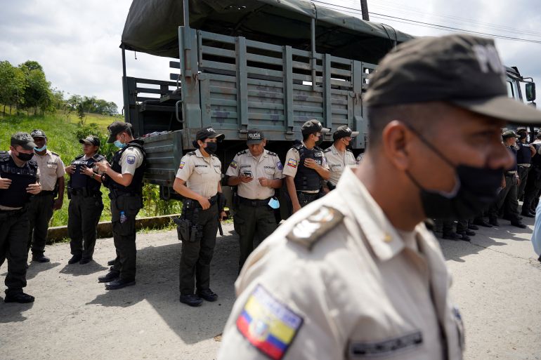 Police officers stand outside the prison in Ecuador