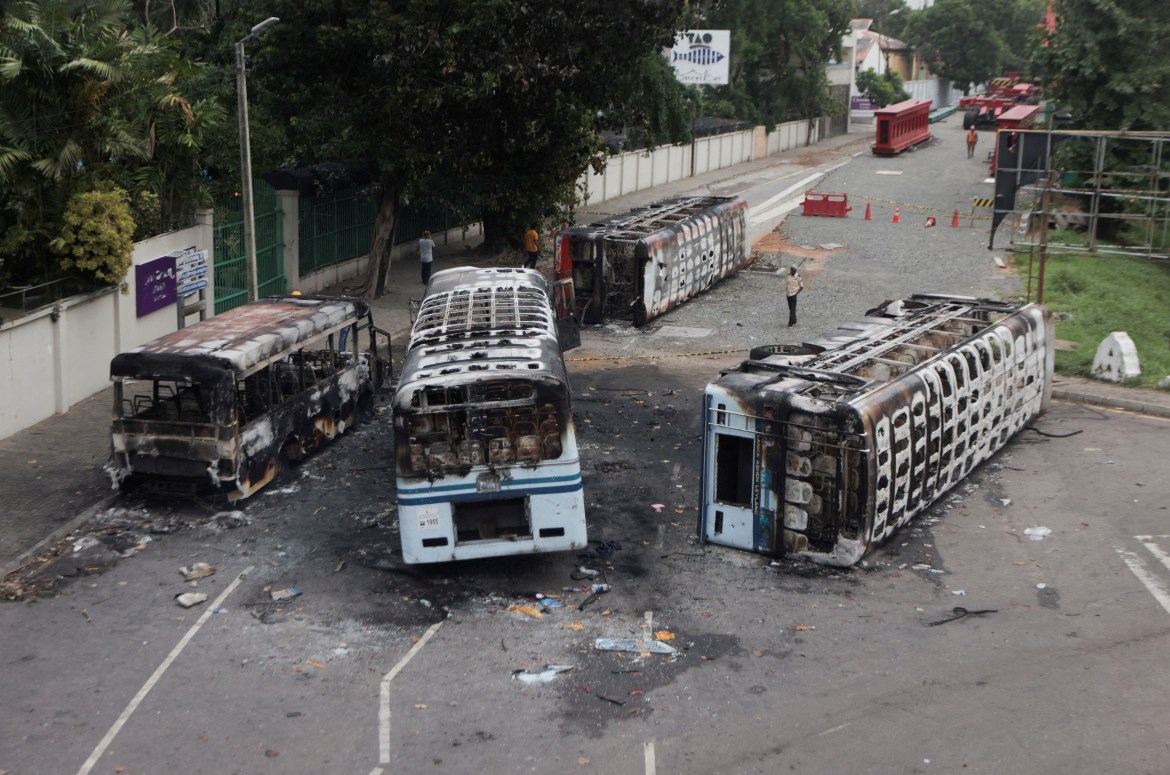 Burnt vehicles of Sri Lanka's ruling party supporters are seen after they were set on fire during a clash of pro and anti-government demonstrators near the Prime Minister's official residence