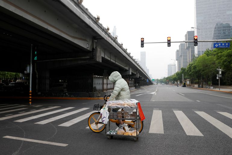 A cyclist crosses an empty highway in Beijing