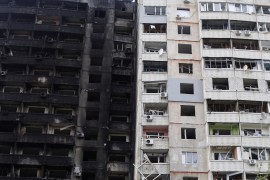 Damaged residential buildings are seen in Kharkiv