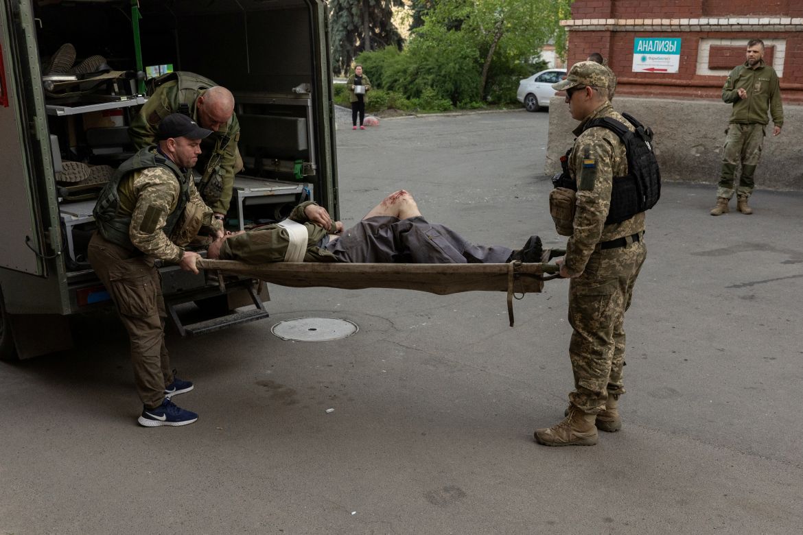 A Ukrainian soldier is carried from an ambulance into a hospital after being injured in combat in Popasna, amid Russia's invasion in Ukraine, at a hospital in Bakhmut, Donetsk region