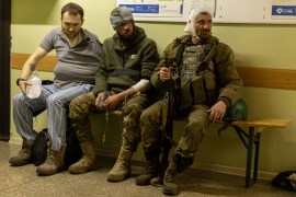 Injured Ukrainian volunteer soldiers on a bench in a hospital in Bakhmut, Donetsk region