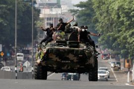 Army members travel on an armoured car on a main road in Colombo, Sri Lanka.