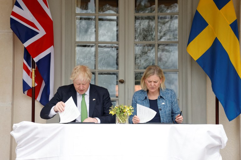 British Prime Minister Boris Johnson and Sweden's Prime Minister Magdalena Andersson sign documents