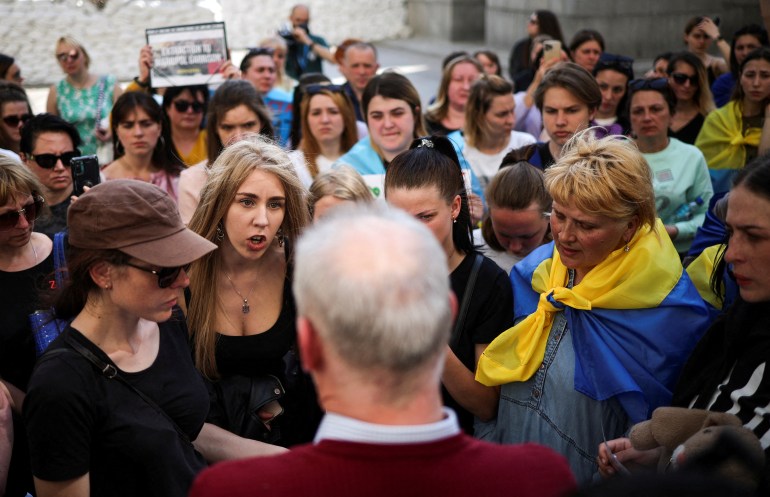 Women, some with the Ukraine flag tied around their shoulders, march to call for the rescue of the soldiers remaining at the Azovstal plant in Mariupol