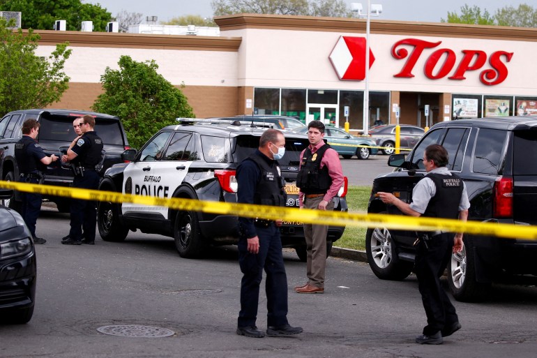 Police officers secure the scene after a shooting at TOPS supermarket in Buffalo, New York, U.S. May 14, 2022.