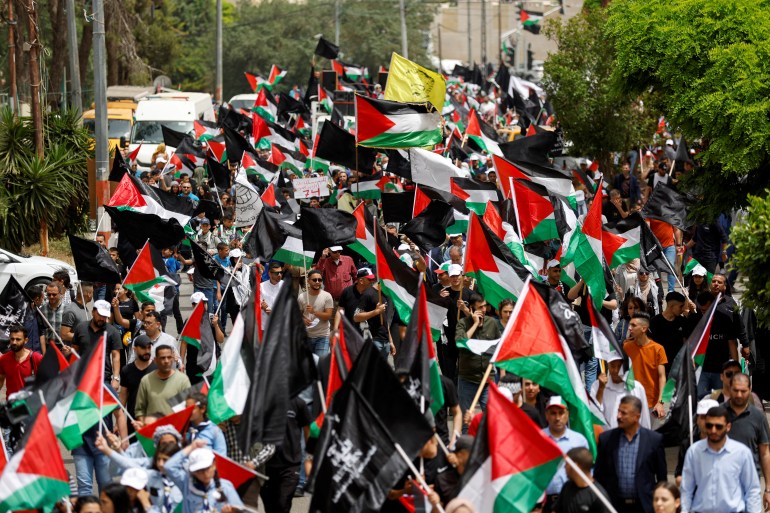 Palestinians take part in a rally marking the 74th anniversary of Nakba or catastrophe, in Ramallah