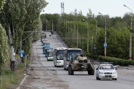 Buses carrying service members of Ukrainian forces who have surrendered