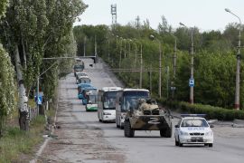 Buses carrying service members of Ukrainian forces who have surrendered