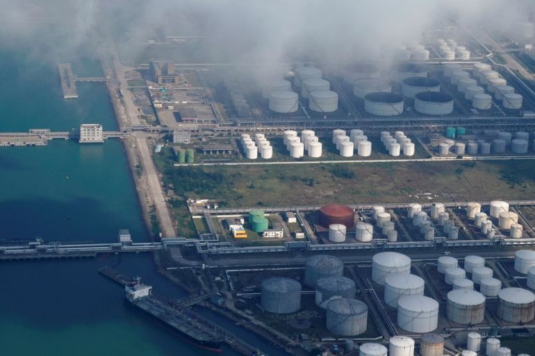 Oil and gas tanks are seen at an oil warehouse at a port in Zhuhai, China