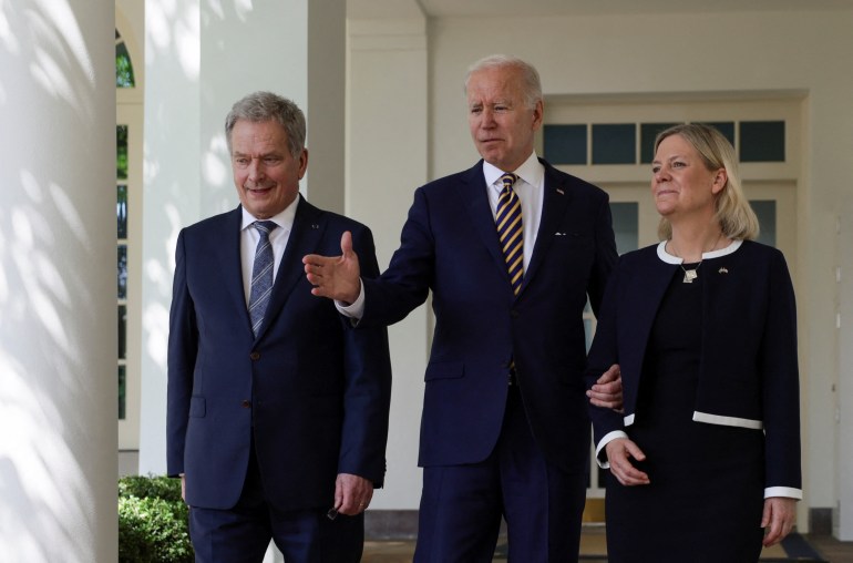 U.S. President Joe Biden walks with Sweden's Prime Minister Magdalena Andersson and Finland's President Sauli Niinisto