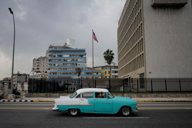 A vintage car passes by the U.S. Embassy in Havana, Cuba.