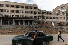 A local resident walks by a destroyed building after a rocket attack on a university campus, amid Russia&#39;s invasion in the Donetsk region, Ukraine [Carlos Barria/Reuters]