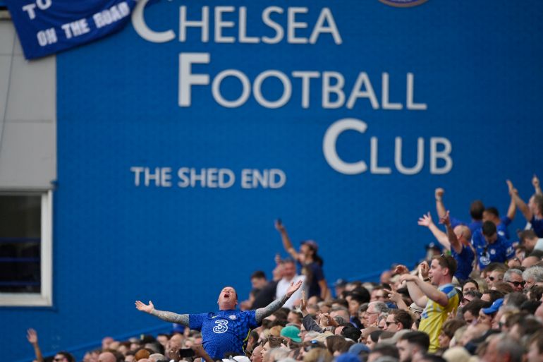 Background of Chelsea Football Club sign with fans inside the stadium during the match.