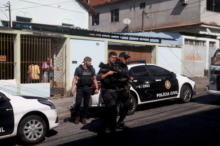 Police officers arrive at the Getulio Vargas Hospital, after more than eleven people were killed during a police operation against drug dealers in the Vila Cruzeiro slum, in Rio de Janeiro, Brazil May 24,