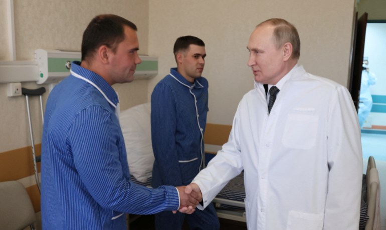 Russian President Vladimir Putin is pictured visiting wounded Russian soldiers