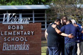 People gather at Robb Elementary School, the scene of a mass shooting in Uvalde, Texas, US, on May 25, 2022 [Nuri Vallbona/Reuters]