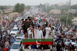 Imran Khan gestures as he travels on a vehicle to lead a protest march in Islamabad [Akhtar Soomro/Reuters]