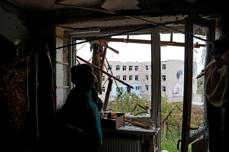 Local resident Natalia Kovalenko, 52, stands inside her apartment damaged during Ukraine-Russia conflict in the town of Popasna in the Luhansk Region, Ukraine May 26, 2022. REUTERS/Alexander Ermochenko