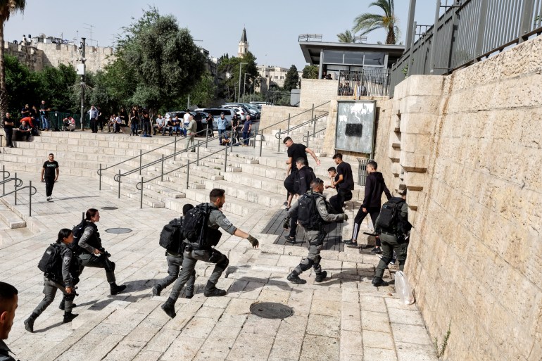 Israeli border police disperse Palestinians from the stairs near Damascus Gate to Jerusalem's Old city