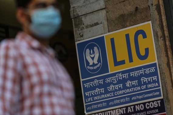 A pedestrian passes a Life Insurance Corp. of India branch office in Mumbai, India