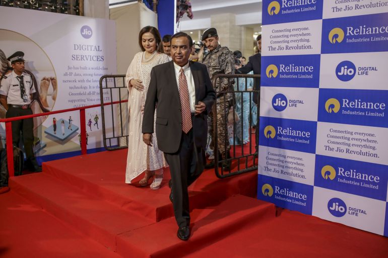 Mukesh Ambani, chairman and managing director of the Reliance Industries Ltd., and his wife Nita Ambani arrive for the company's annual general meeting in Mumbai, India