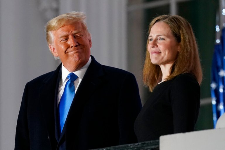 President Donald Trump and Amy Coney Barrett stand on the Blue Room Balcony after Supreme Court Justice Clarence Thomas administered the Constitutional Oath to him on the South Lawn of the White House in Washington, Monday, October 26, 2019. 2020. 