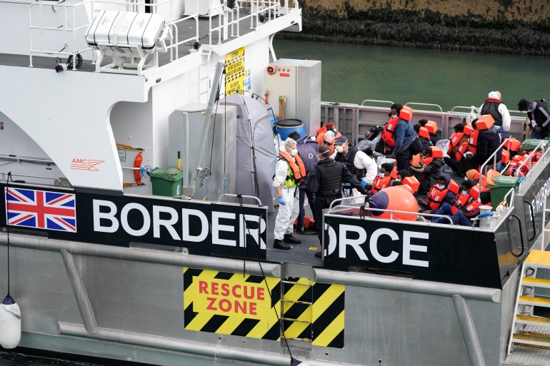 People thought to be refugees and migrants who made the crossing from France are brought into port after being picked up in the Channel by a UK border force vessel in Dover, south east England.