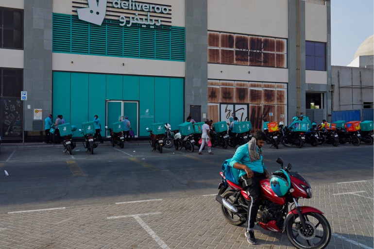 Delivery drivers for the app Deliveroo wait for orders, in Dubai,