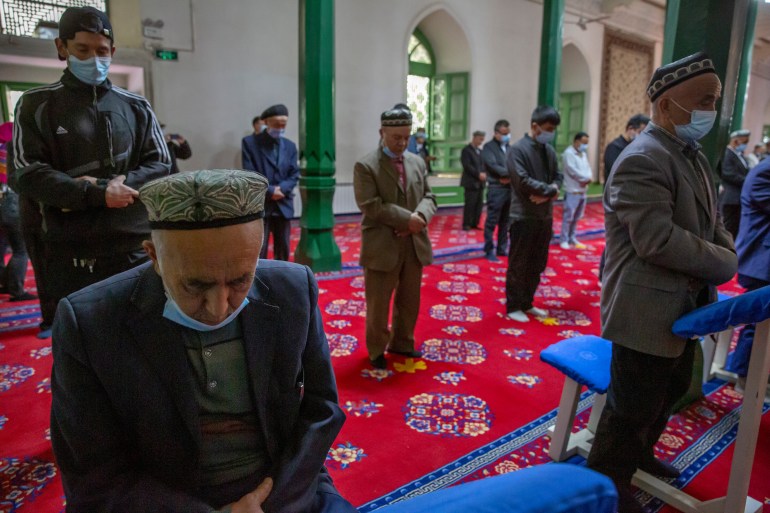 Uyghurs and other members of the faithful pray during services at the Id Kah Mosque in Kashgar in far west China's Xinjiang region, as seen during a government organized visit for foreign journalists on April 19, 2021.
